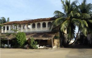 Un immeuble colonial envahi par la végétation mais toujours habité à Grand-Bassam (Côte d'Ivoire)