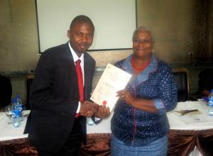 A graduate of the leadership-seminar of the Centre-LSD is presented his certificate at the yearly conference at 18 March, 2015 in Abuja, Nigeria.