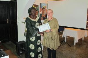 Hildegard Behrendt-Kigozi, Head of Konrad-Adenauer-Stiftung in Nigeria hands over a certificate of participation at a Workshop on training manuals for Nigerian security forces at 26 November, 2014 in Abuja.