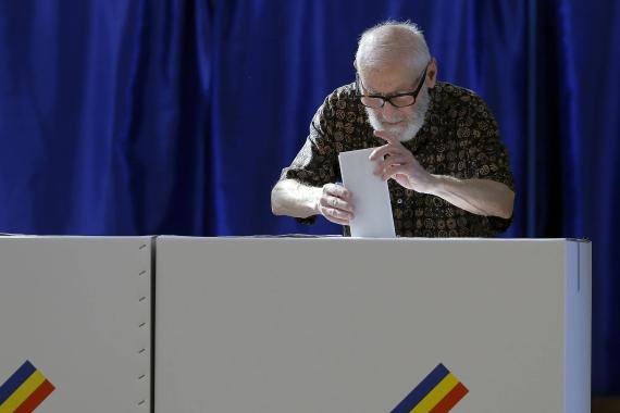 A man votes for the European Parliament elections and local elections at a polling station in Bucharest